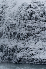 Fototapeta na wymiar Icelandic frosty frozen close-up nearby a waterfall in winter time 