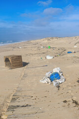 Fototapeta na wymiar Trash littering sandy beach on a warm winter day near Lisbon, Portugal.