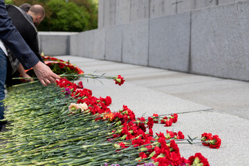 Red carnations were laid in honor of the fallen soldiers at the marble memorial. Symbol of victory...