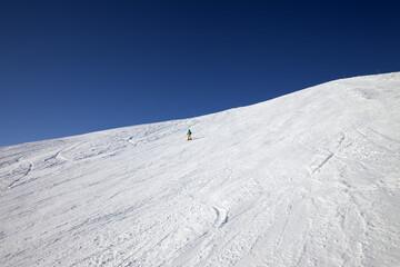 Skier on slope in sun day - 575428185