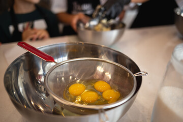 eggs in a bowl on the kitchen table for making a pie at a culinary master class