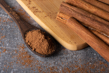 Cinnamon sticks on a wooden background. Cinnamon spice in a spoon and bowl. Ceylon cinnamon.