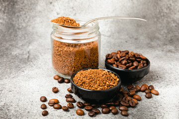 Ingredients for making coffee - coffee beans, ground and instant coffee on a black textured background. Caffeine. Decaffeinated coffee. Aroma energy hot drink. Place for text, space for copy.