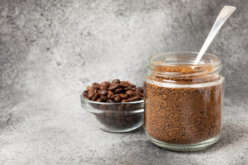 Ingredients for making coffee - coffee beans, ground and instant coffee on a black textured background. Caffeine. Decaffeinated coffee. Aroma energy hot drink. Place for text, space for copy.