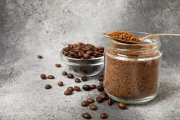 Ingredients for making coffee - coffee beans, ground and instant coffee on a black textured background. Caffeine. Decaffeinated coffee. Aroma energy hot drink. Place for text, space for copy.