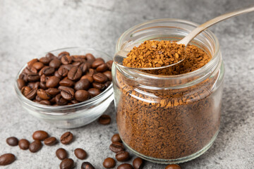 Ingredients for making coffee - coffee beans, ground and instant coffee on a black textured background. Caffeine. Decaffeinated coffee. Aroma energy hot drink. Place for text, space for copy.