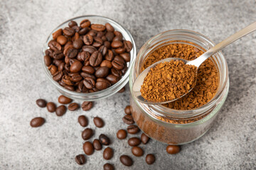 Ingredients for making coffee - coffee beans, ground and instant coffee on a black textured background. Caffeine. Decaffeinated coffee. Aroma energy hot drink. Place for text, space for copy.