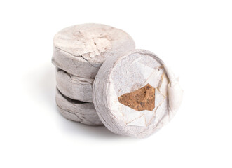 Naklejka premium Peat tablets or briquettes for sprouts. Isolated on white background