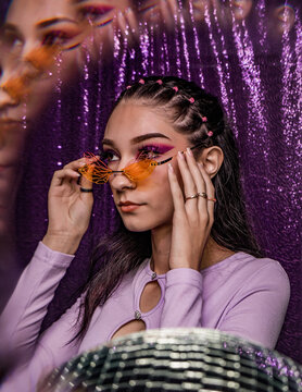 euphoria inspired editorial photo shoot glitter background purple black model caucasian hispanic model fashion photo shoot party dance disco queen ball glasses hairstyle 90s 20s hbo