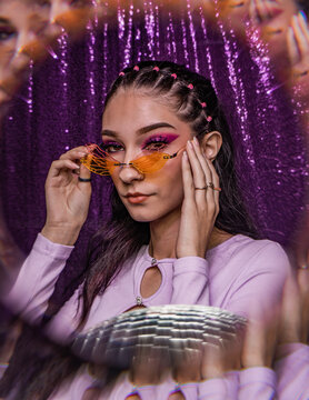 euphoria inspired editorial photo shoot glitter background purple black model caucasian hispanic model fashion photo shoot party dance disco queen ball glasses hairstyle 90s 20s hbo