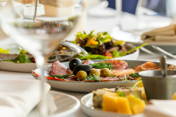 cold cuts with olives and black olives on a served table