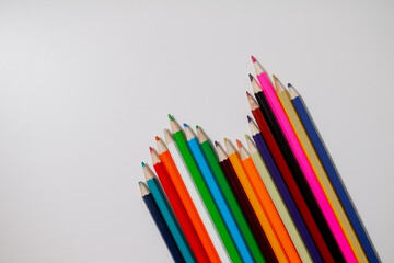 Set of colourful pencils on white paper background set in wavy line 