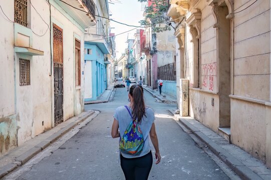 Woman tourist walking through the streets of Old Havana in Cuba.