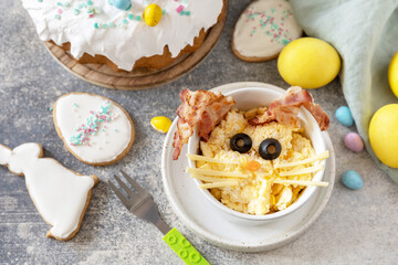 Easter breakfast idea. Scrambled eggs easter bunny on a stone background.