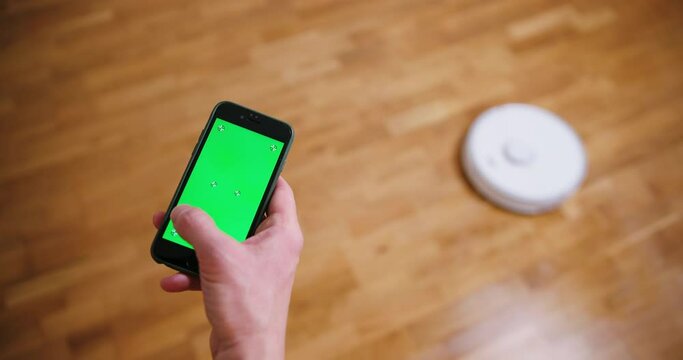 Robot vacuum cleaner performs automatic cleaning of the house at a certain time. Smart home concept. Copy space