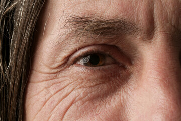 Close up image of aged man's eye, looking at camera