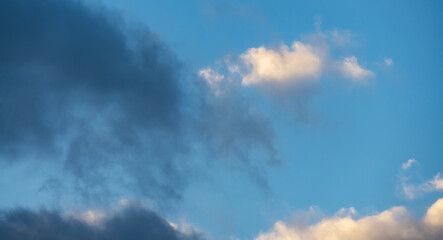 Naklejka na ściany i meble Beautiful clouds on the blue sunset sky. Sky clouds background.