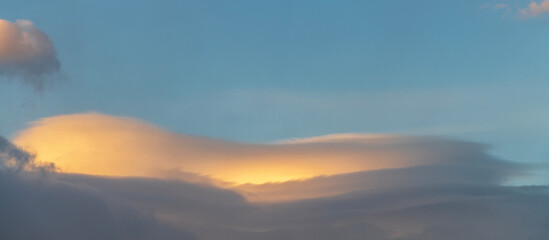 Beautiful orange clouds on the  blue sunset sky. Sky clouds background. 