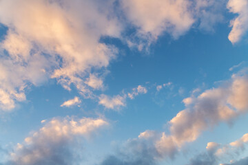 Naklejka na ściany i meble Beautiful orange clouds on the blue sunset sky. Sky clouds background.