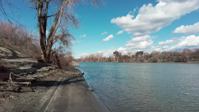 Pretty cloudy spring day on the levee shoreline of the sacramento river in nothern california 