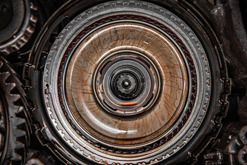 Gears, cogs and bearing of a dissasembled gearbox in a garage ready for repair