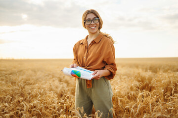 Farmer woman in a wheat field. Wheat quality check. Agriculture, gardening or ecology concept.