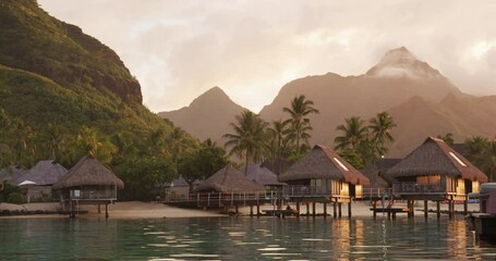 Travel vacation luxury resort hotel overwater bungalows on paradise beach. Romantic holidays retreat or honeymoon destination. French Polynesia. Nobody, SLOW MOTION