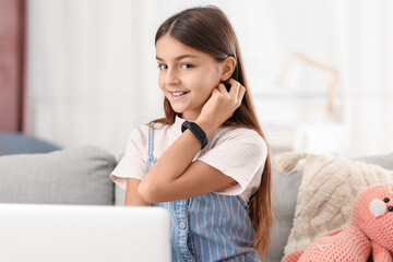 Little girl with smartwatch at home