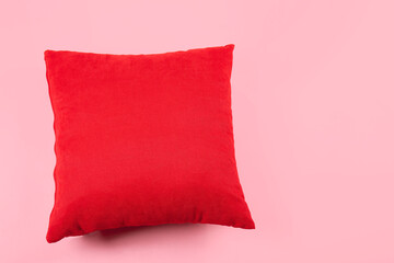 Red pillow on pink background