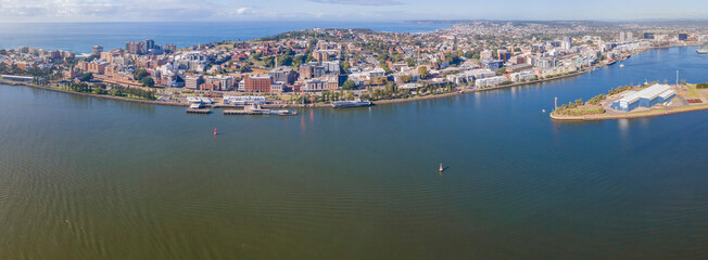 Panoramic aerial drone view of the harbour city of Newcastle, NSW, Australia looking from above Newcastle Harbour on a sunny day 