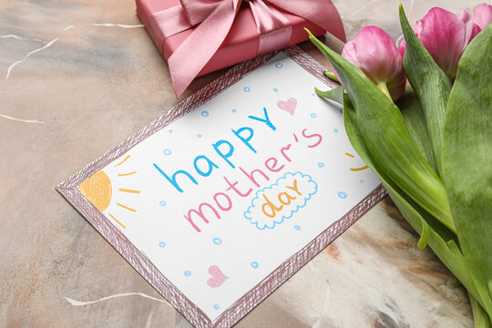 Picture with text HAPPY MOTHER'S DAY, tulip flowers and gift box on grunge background, closeup