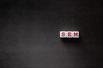 There is white cube with the word SEM. It is an abbreviation for Search Engine Marketing as eye-catching image.