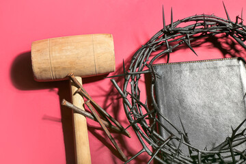 Fototapeta na wymiar Crown of thorns with Holy Bible, nails and mallet on red background, closeup