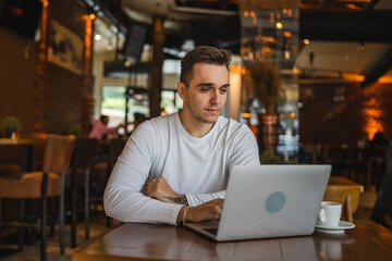 one man work on laptop computer at cafe with bad news worried