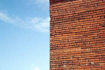 Wall of red brick and blue sky.