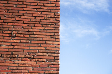 Wall of red brick and blue sky.
