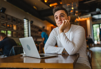 Obraz premium one man work on laptop computer at cafe with bad news worried
