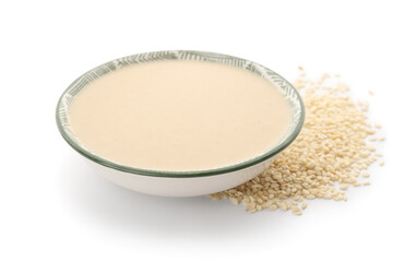 Bowl of tasty tahini isolated on white background