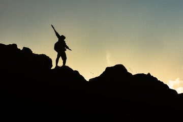 Hiker with arms up standing on the top of the mountain - Successful man enjoying triumph - Sport...