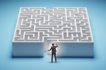 Businessman trying to find a way out of maze