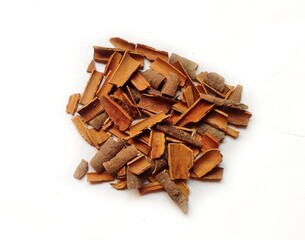 Cinnamon sticks, pieces with shavings isolated on white, top view