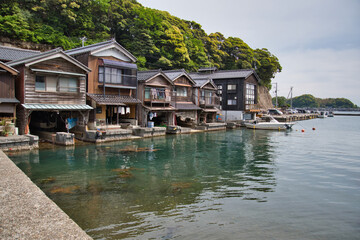 Fototapeta na wymiar Ine no funaya. The well-known boathouses in the inlet of Ine town. Kyoto, Japan 
