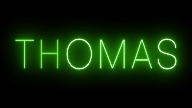 Flickering green retro neon sign glowing against a black background for THOMAS