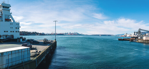 Harbor port facility panorama with view of downtown cityscape on a sunny day. Panoramic scenery...