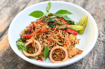 noodles plate with instant noodles stir fried with vegetables herb spicy tasty appetizing asian noodles mix seafood stir fried squid with basil and chilli pepper