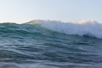 Wave foam breaking in the ocean.