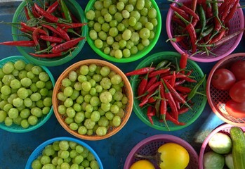 Plenty of fruits and vegetables ready to cook , star gooseberry, tomato, fresh chili