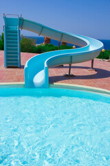 Stylishly interesting water slide in the pool near the sea on nature background