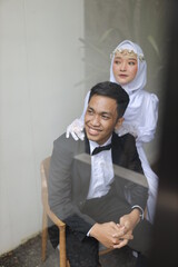 romantic prewedding photo couple of asian man and asian girls wearing neat suits black suits and white dresses indoor concept