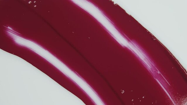 Magento. Red lipstick. Ink on white background. Smudge paint. Decorative cosmetics. Screensaver. Сreate abstract art. Watercolor, acrylic, oil, and pastel. Product related to makeup and cosmetics.